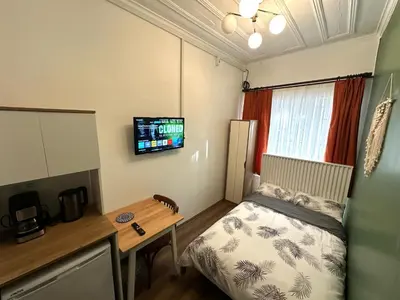 a small room with a bed and a desk at Yellowhouse Room 1 in Istanbul
