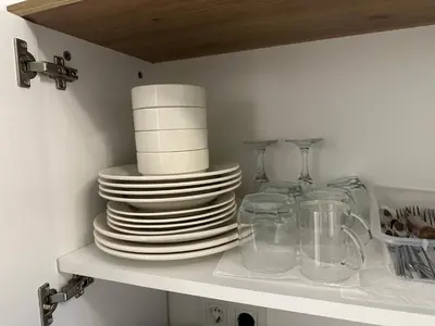 a shelf with a stack of plates and glasses at Yellowhouse Room 1 in Istanbul