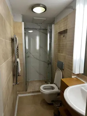 a bathroom with a shower and a toilet and a sink at D&D Pansiyon in Istanbul