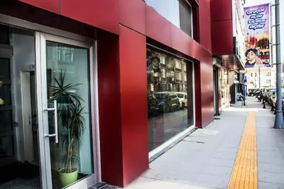 a red facade of a building with a sidewalk at D&D Pansiyon in Istanbul