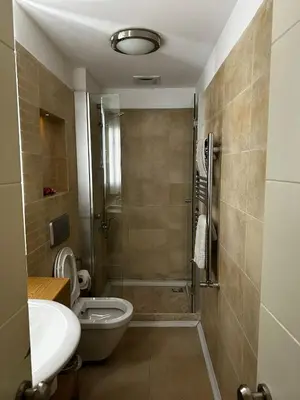 a bathroom with a shower and a toilet and a sink at D&D Pansiyon in Istanbul