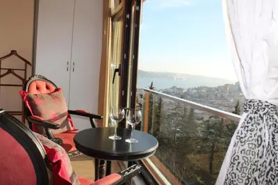 a balcony with a table and two wine glasses at Bude Ortaköy in Istanbul
