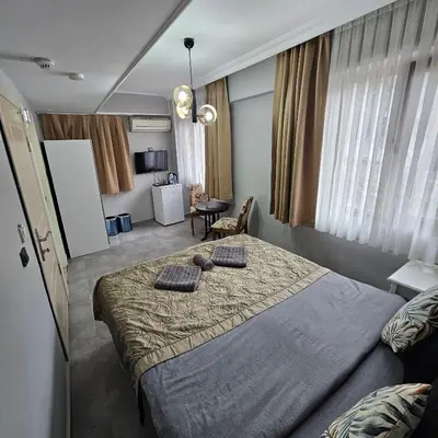 a bedroom with a large bed with two pillows on it at Bude Ortaköy in Istanbul