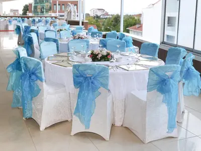 a group of tables with blue bows on them at Helenapolis OTEL in Yalova