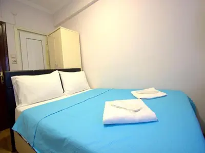 a blue bed with two towels on top of it at Simge in Istanbul