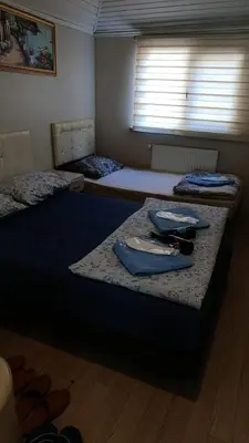 a room with three beds and a window at Simge in Istanbul