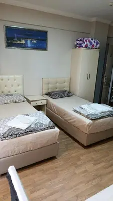 a room with two beds and a cabinet at Simge in Istanbul