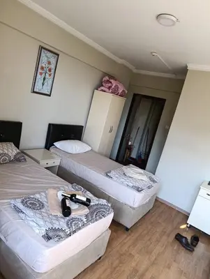 a room with two beds and a mirror at Simge in Istanbul