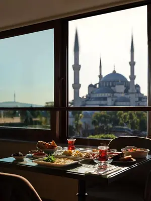 a table with food on it with a view of a mosque at 1207 Hotel Special Class Sultanahmet in Istanbul