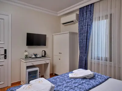 a hotel room with two beds and a television at 1207 Hotel Special Class Sultanahmet in Istanbul