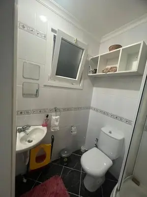 a small bathroom with a toilet and a sink at Villa Elegance in Kocaeli