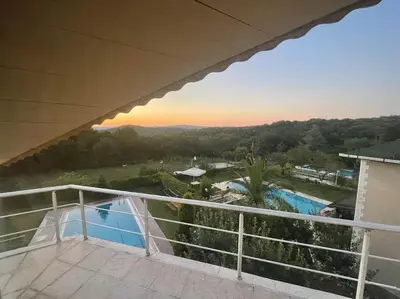 a balcony with a view of a swimming pool at Villa Elegance in Kocaeli