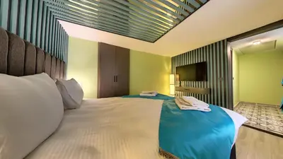 a bedroom with a large bed with a blue blanket at Wonder House Sultanahmet in Istanbul