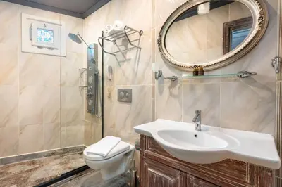 a bathroom with a sink and a toilet and a mirror at Wonder House Sultanahmet in Istanbul