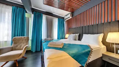 a bedroom with a large bed and a chair at Wonder House Sultanahmet in Istanbul