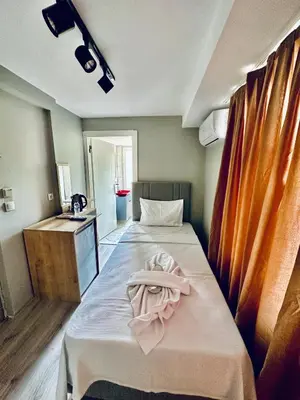 a room with a bed with a towel on it at The Hera Gold Hotel in Istanbul