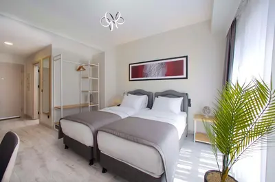 a bedroom with a large bed and a potted plant at Best Western Plus Hotel & Residences Istanbul in Istanbul