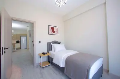 a white bedroom with a bed and a hallway at Best Western Plus Hotel & Residences Istanbul in Istanbul