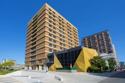 a large building with a yellow and black building at Best Western Plus Hotel & Residences Istanbul in Istanbul