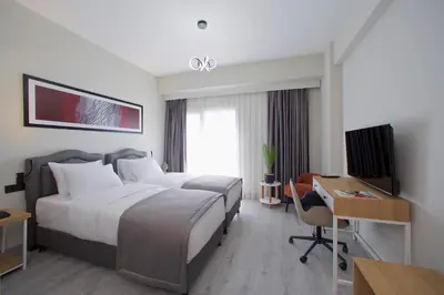 a hotel room with a bed and a desk and a computer at Best Western Plus Hotel & Residences Istanbul in Istanbul