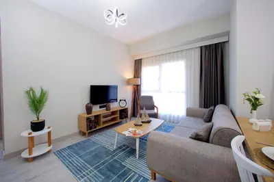 a living room with a couch and a tv at Best Western Plus Hotel & Residences Istanbul in Istanbul