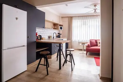 a kitchen with a table and stools in a room at AKA Home in Istanbul