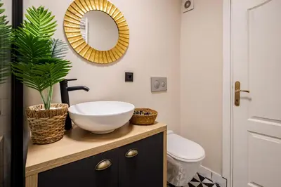 a bathroom with a sink and a toilet and a mirror at AKA Home in Istanbul