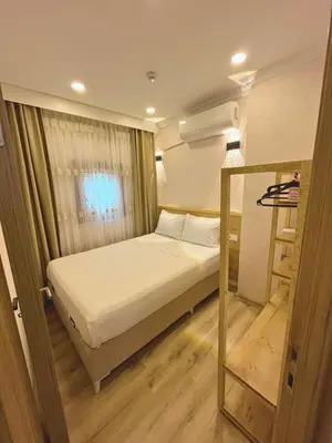 a small bedroom with a bed and a window at Dila Apart Hotel in Istanbul