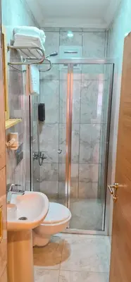 a bathroom with a shower and a toilet and a sink at Dila Apart Hotel in Istanbul