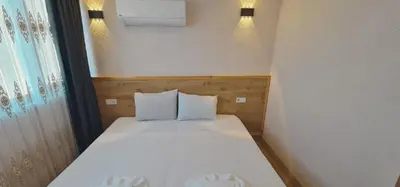 a small bedroom with a white bed with two pillows at Dila Apart Hotel in Istanbul