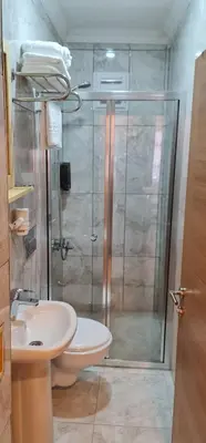 a bathroom with a shower and a toilet and a sink at Dila Apart Hotel in Istanbul