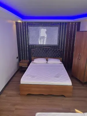 a bedroom with a large bed with a wooden headboard at Hisar Çeşme Hotel in Istanbul
