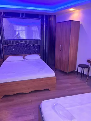 a bedroom with a large bed with a wooden headboard at Hisar Çeşme Hotel in Istanbul