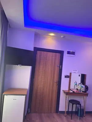 a room with a wooden door and a table and a table sidx sidx at Hisar Çeşme Hotel in Istanbul