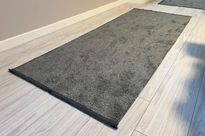 a black rug on the floor in a room at Bro Apartments Sultanahmet in Istanbul
