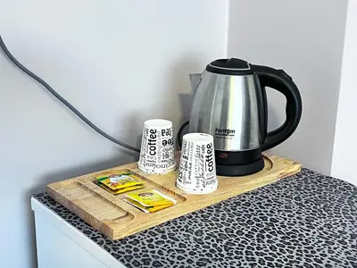a coffee pot on a wooden tray with two cups at Bro Apartments Sultanahmet in Istanbul
