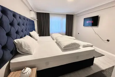 a bedroom with a large bed with a blue headboard at Bro Apartments Sultanahmet in Istanbul