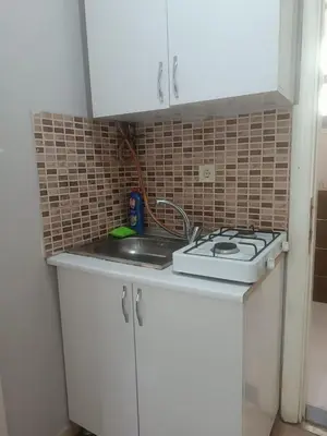a kitchen counter with a sink and a stove at Taksim Dora Apart in Istanbul