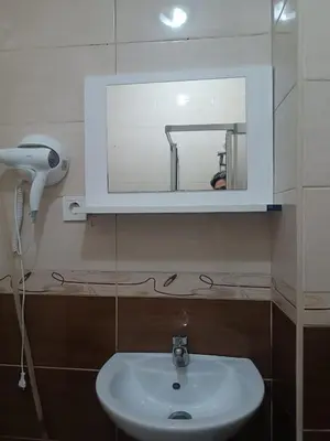 a bathroom with a white sink and a mirror at Taksim Dora Apart in Istanbul