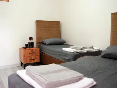 a bedroom with two beds and a dresser with towels at Mimen Hostel in Istanbul