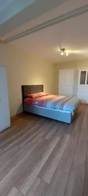 a bedroom with a bed and a wooden floor at Stone Garden Apartment in the Heart of the City in Istanbul