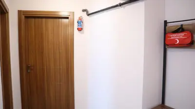 a room with a door and a fire extinguisher at Cozy Duplex Next to Green Masjid in Yıldırım