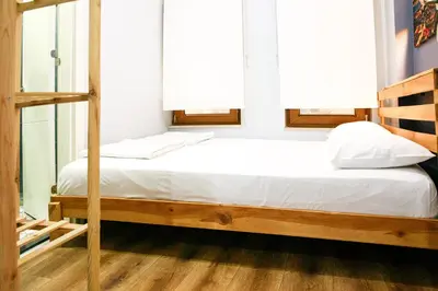 a bed with white sheets and pillows in a room at Beans House Suite 8-26 in Istanbul