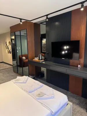 a hotel room with a bed and a flat screen tv at Zeytin Hotel in Istanbul