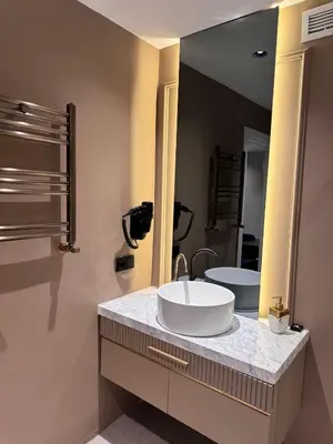 a bathroom with a sink and a large mirror at Zeytin Hotel in Istanbul