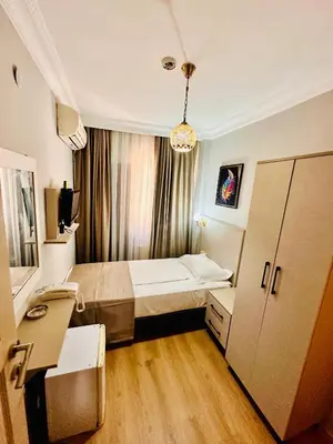 a small room with a bed and a desk at Crowned Exclusive Hotel in Istanbul