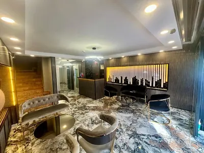a lobby with a marble floor and chairs and a piano at Crowned Exclusive Hotel in Istanbul