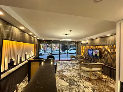 a lobby with a bar with chairs and a television at Crowned Exclusive Hotel in Istanbul