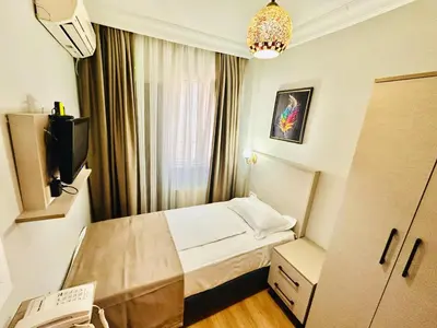 a small room with a bed and a television at Crowned Exclusive Hotel in Istanbul