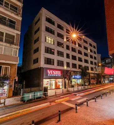a building on a city street at night with cars at Roys Hotel & Suites in Istanbul